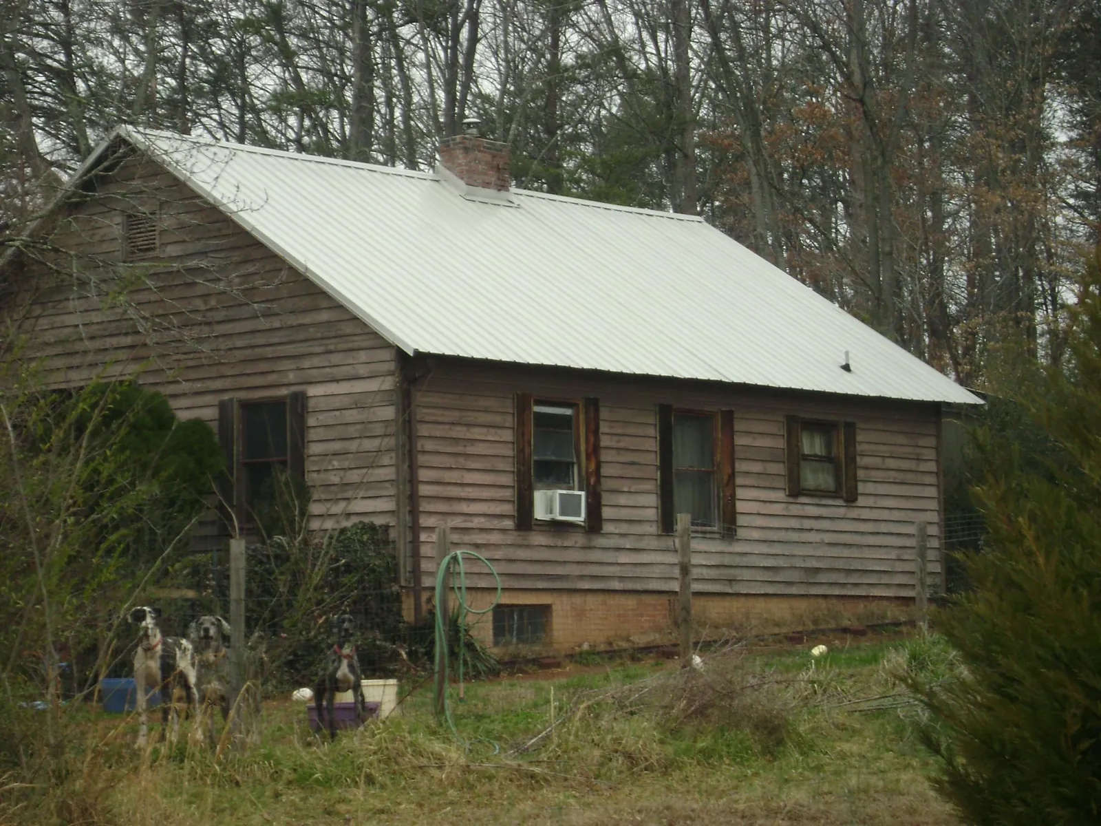 White metal roof on an old wood sided farmhouse, from a Metal Roof Installation job in Sunburg